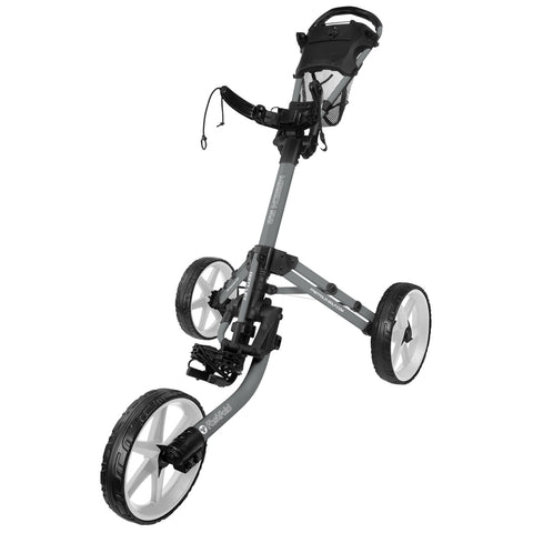 A golf push cart with a three-wheel design stands upright features a padded handle and a storage basket for accessories suitable for transporting golf bags across a course.