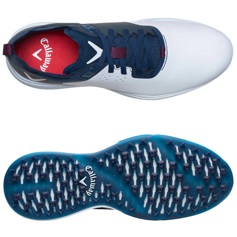 A golf shoe features a white upper with navy accents and red interior while the outsole has a blue grip pattern designed for traction on the course.