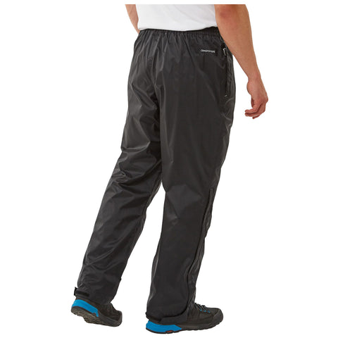 Black waterproof pants are worn by a person facing away while standing. The setting appears casual, suitable for outdoor activities or light exercise, with nature likely surrounding them.