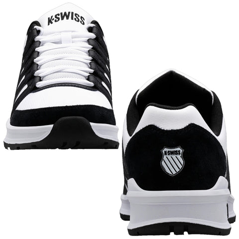 Black and white athletic shoes are displayed centrally with visible laces and branding the shoes have a smooth upper and a rugged sole suggesting suitability for sports or casual wear