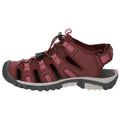 A maroon sandal with pink accents features an open-toe design and multiple straps. It is equipped with a quick-lacing system and a rugged outsole for outdoor use.