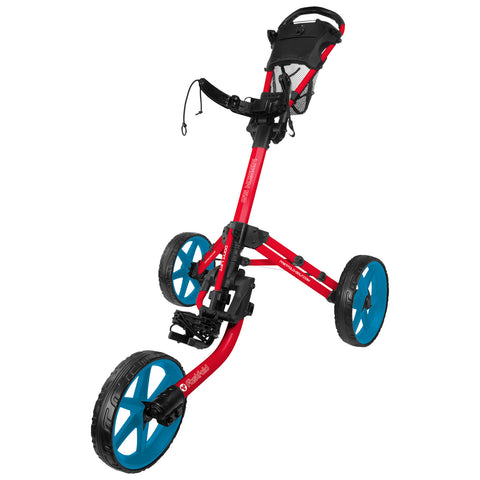 A red and blue golf pushcart stands upright with three wheels featuring a foot brake and a handle for steering located at the top designed for transporting golf clubs and equipment.