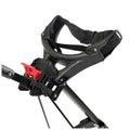 A black and red stroller handle features a sturdy grip with an adjustable strap and a locking mechanism, situated in a neutral environment indicating its readiness for use.