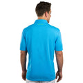 A person wears a bright blue polo shirt facing away from the viewer with short sleeves and a collar the context is a neutral background emphasizing the shirt's color and style. Text on the back reads LIVE LUCKY.