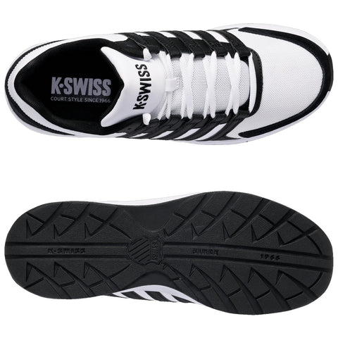 A black and white athletic shoe rests flat showcasing its mesh upper and rubber sole with ridges highlighting its design perfect for sport activities and casual wear. Text reads K-SWISS COURT STYLE SINCE 1966.