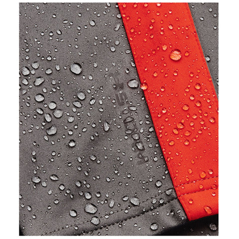 A grey fabric surface with water droplets is prominently displayed alongside a bright red stripe, indicating exposure to moisture in a potentially outdoor or rainy environment.