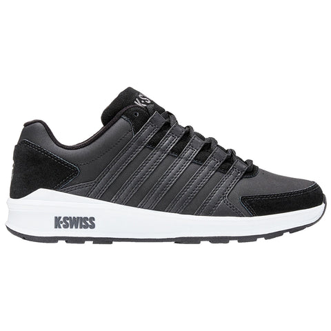 A black athletic shoe with a sleek design features multiple horizontal stripes and a white sole positioned on a plain background, emphasizing its sporty and modern appearance.