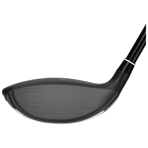 A golf club head is shown tilted with a smooth black striking surface and a polished edge the club is positioned for a swing against a plain white background.