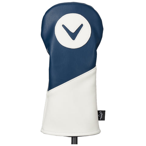 A golf club headcover is displayed prominently with a rounded top featuring a circular logo and contrasting blue and white sections providing protection and style in a display setting.