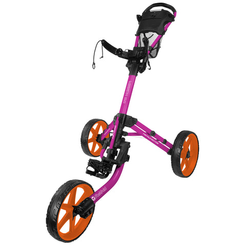 A colorful golf push cart with a bright pink frame and orange wheels is positioned upright, designed for transporting golf bags on the course, featuring a comfortable handle and sturdy construction.