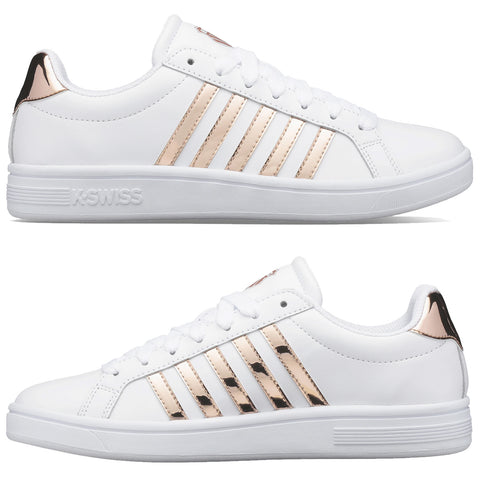 White athletic shoes with rose gold metallic stripes are displayed from two angles highlighting laces and branding on the sides and backs situated on a plain background.