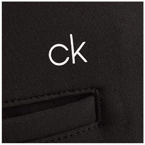 A black fabric surface features a small white logo displaying the letters "ck" with a cut-out pocket below it in a simple, minimalistic design.