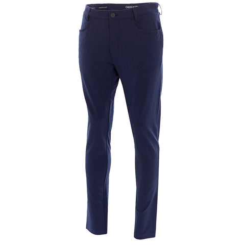 Navy blue pants are displayed upright showcasing a slim fit design with pockets and a button closure situated against a plain white background.