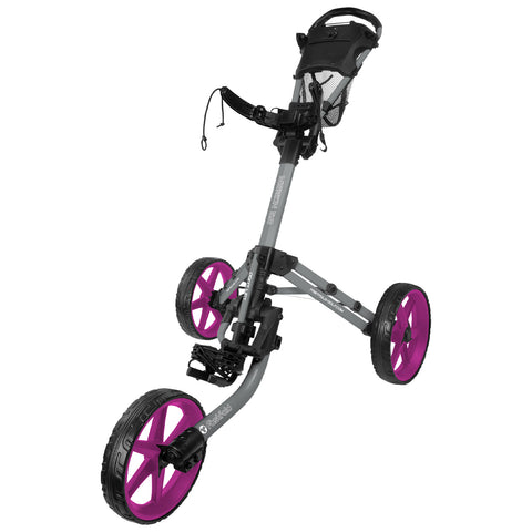 A golf push cart stands upright with three wheels the front wheels are pink and designed for mobility while the handle features a mesh pocket for storage