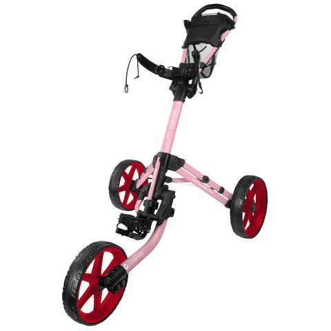 A golf push cart features a pink frame and red wheels standing upright. The cart has a seat and mesh storage at the top, designed for transporting golf clubs on a course.