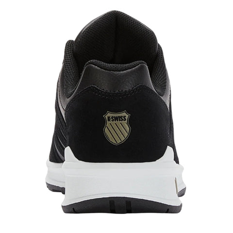 A black athletic shoe with a textured surface features a prominent K-Swiss logo on the heel area. It is positioned against a simple white background, highlighting its design.