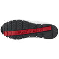 A sneaker sole is shown with textured patterns for traction the brand name stuburt is embossed in red across the midsection emphasizing durability and purpose.