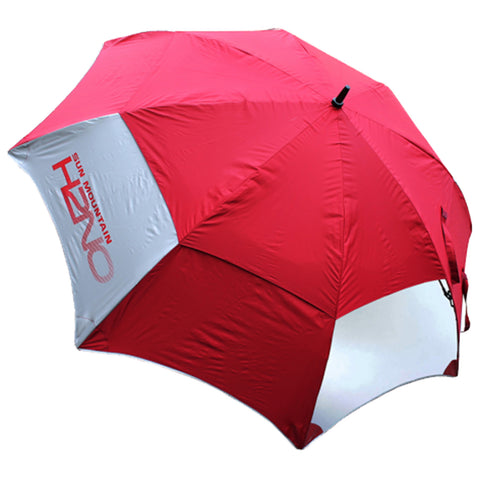 A large red and white beach umbrella is positioned upright providing shade its fabric is taut and smooth the scene is likely outdoor near sand or grassy areas where sun protection is needed.