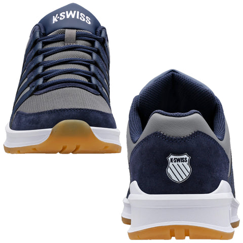 Navy blue athletic shoes with gray mesh and suede materials display a streamlined design featuring laces and a logo. They are positioned upright against a plain white backdrop.