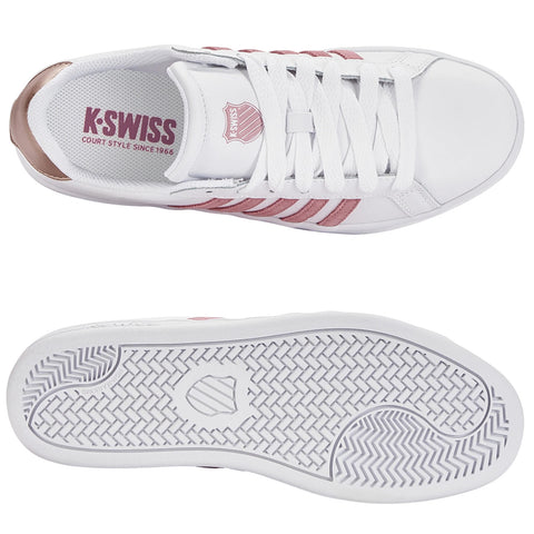 White athletic shoes with rose-colored stripes are positioned with the top view visible. The shoe's design features a logo and a textured white sole. The interior includes text about the brand and model.