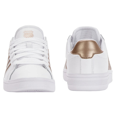 A pair of white sneakers with gold accents are displayed side by side showcasing their sleek design the shoes feature white laces and a textured gold heel accent