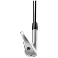 A golf club is positioned upright showcasing its polished silver clubhead and black shaft emphasizing its sleek design intended for striking a golf ball on the course.