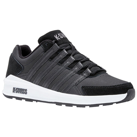 Black athletic sneaker with a sleek design features multiple laces and a contrasting white sole displayed against a neutral background suggesting a focus on sports or casual wear.