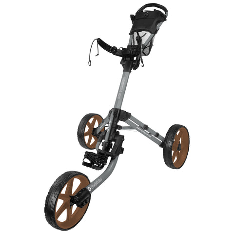 A golf pushcart with a three-wheeled design stands upright featuring large brown wheels and a handlebar with a mesh storage compartment for easy maneuvering on the golf course.