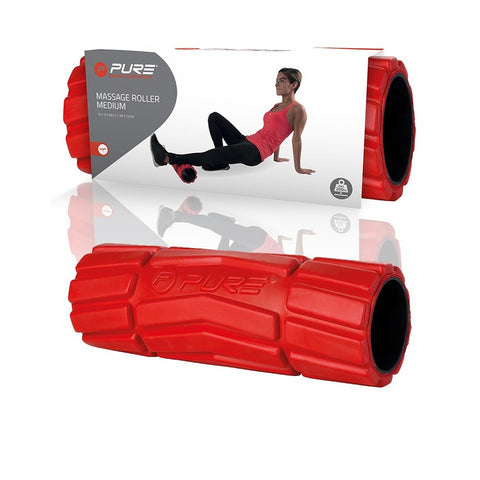 A red massage roller lies in the foreground with a woman in workout attire using it on her leg in the background against a display showing the product name and features.