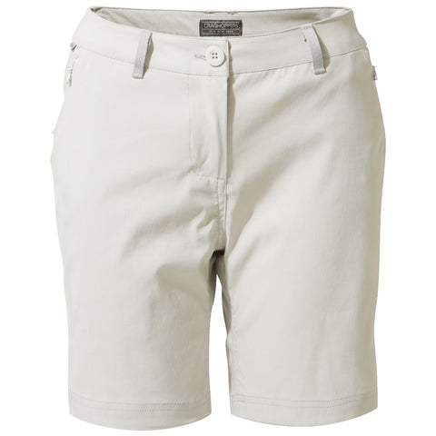 Light beige shorts are worn by a person standing upright who is wearing gray and orange athletic shoes in a neutral setting suitable for outdoor activities.