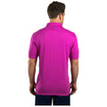 A man is standing with his back turned, wearing a bright pink polo shirt. The shirt has a collar and short sleeves, and the phrase "LIVE LUCKY" is visible on the back near the collar.