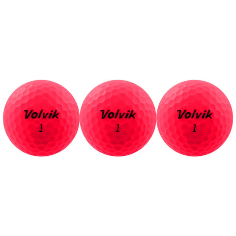 Three bright pink golf balls are arranged in a row displaying the brand name Volvik and the number one on their surfaces. They are set against a plain background.