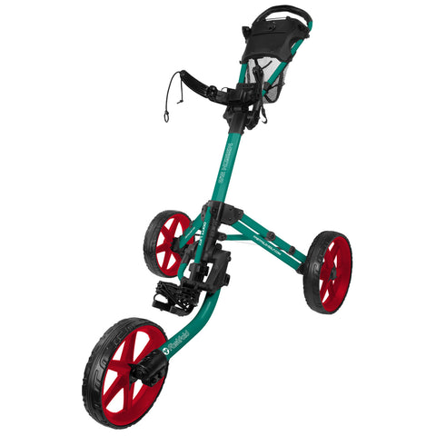 A golf push cart stands upright with three wheels. The cart is green and black with red wheels and features a handlebar and storage compartment, typically used on golf courses.