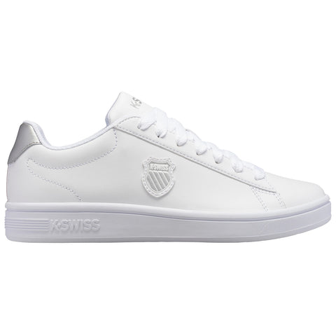 A white sneaker with round laces features a distinctive logo on the side and a smooth surface showcasing a minimalist style set against a plain background.