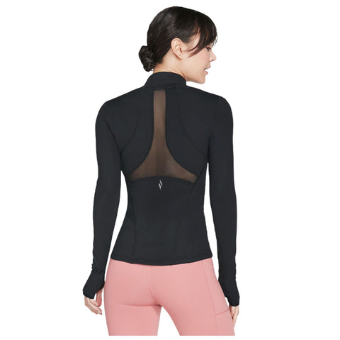 A person is wearing a black long-sleeve athletic top with a mesh back while standing sideways. They also wear pink athletic pants, showcasing a stylish and sporty look.