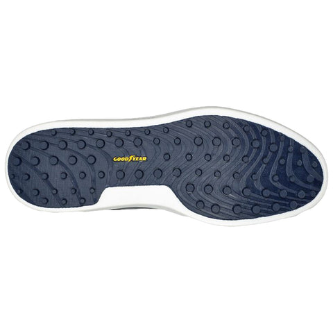 A shoe sole features a navy rubber surface with raised circular patterns for grip showcasing a white border and the word GOODYEAR prominently displayed in yellow on the sole.