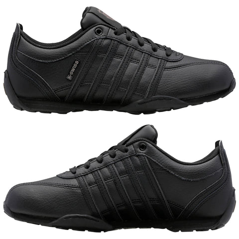 Black sports shoes with a sleek design feature a textured leather exterior and multiple horizontal stripes. They are positioned side by side against a plain background.