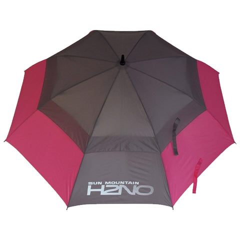 A large umbrella features alternating tones of gray and pink panels. It is open and displayed flat, designed for sun protection, likely positioned outdoors or in a recreational setting.