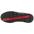 A shoe sole is shown with a textured black surface and a red stripe featuring the word stuburt embossed in it, emphasizing grip and stability for outdoor or athletic use.