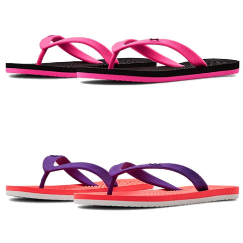 Under Armour Junior Atlantic Dune II Sandals 3022732 Two pairs of flip-flops are displayed with the top pair in pink and black and the bottom pair in purple and coral. They are positioned parallel to each other against a white background.