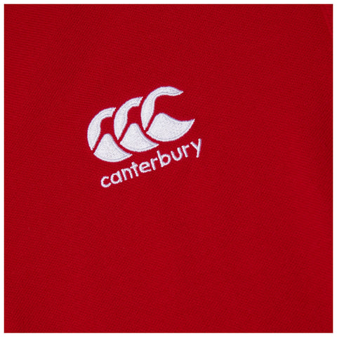 A red fabric displays a white embroidered logo consisting of three overlapping shapes resembling stylized 'C's above the word canterbury. The overall look suggests athletic or sports apparel.