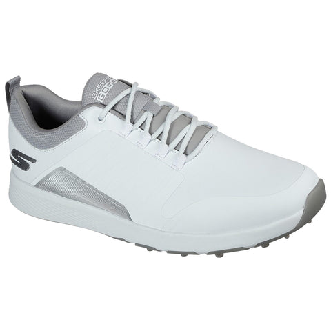 A white golf shoe is positioned diagonally with laces threaded through eyelets showcasing a sleek design and gray accents highlighting its sporty aesthetics in a neutral background.