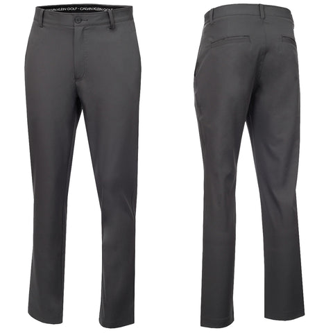 Slim-fit black golf pants hang in a front and back view showcasing a smooth fabric texture with a waistband label indicating the Calvin Klein Golf brand and back pockets for practicality.