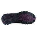 A black shoe sole is presented showcasing a textured purple insert and various tread patterns suggesting grip and stability suitable for outdoor activities on varied terrains.