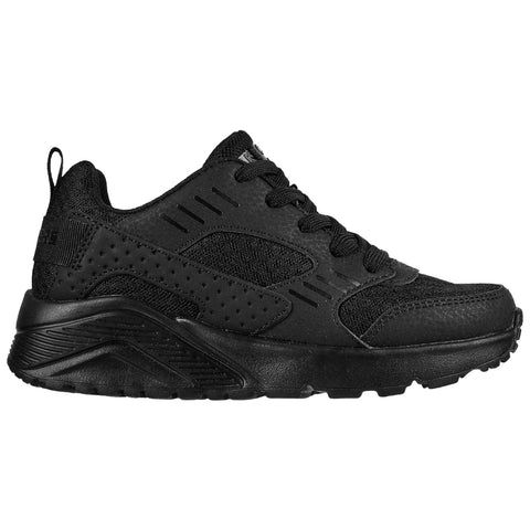 A black athletic shoe features a textured upper with mesh panels and a thick sole providing support designed for casual wear or exercise likely displayed on a plain background.