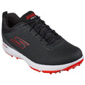 A black and red athletic shoe rests upright with a ribbed texture and lace-up design featuring a white sole and protruding spikes for traction during sports activities.