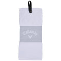 A white golf towel with a textured upper section and a smooth middle band displays the logo Callaway. It features a loop for hanging, suitable for use on the golf course.