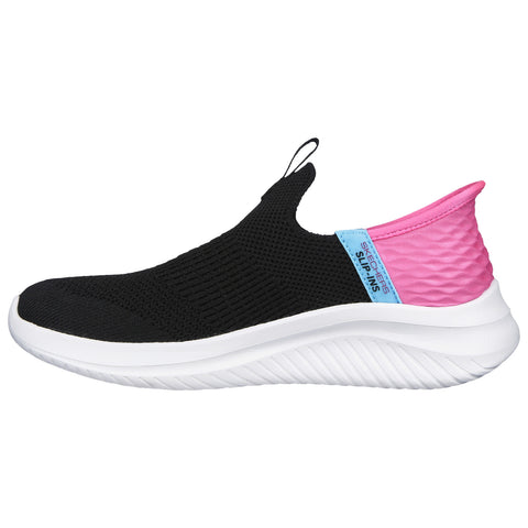 A black slip-on shoe features a breathable upper and a white sole with a textured pink and blue heel tab providing comfort and style suitable for casual wear.