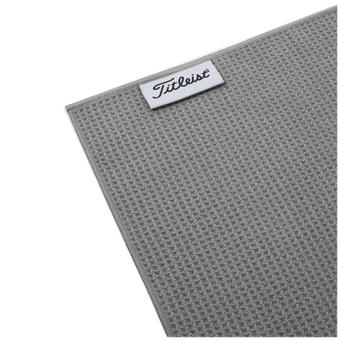 A gray textured towel is displayed with a white branded label at the top reading Titleist. The towel appears soft and suitable for drying or cleaning.