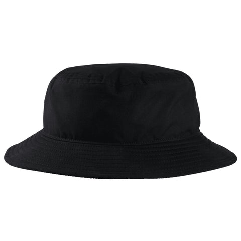 A black bucket hat rests upright on a flat surface showcasing its round crown and wide floppy brim in a minimalist setting emphasizing its simple design and color.